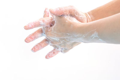 Close-up of human hand against white background