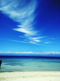 Scenic view of beach against blue sky