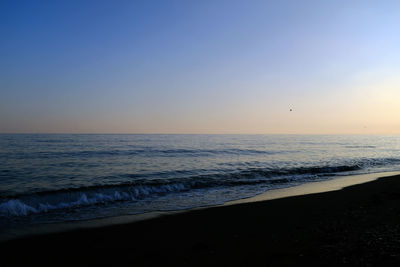 Scenic view of sea against clear sky during sunset
