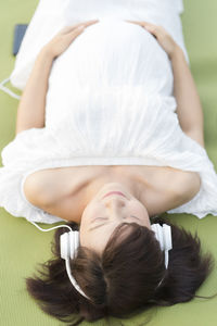 Midsection of woman lying on sofa