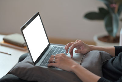 Midsection of woman using laptop