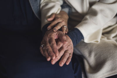 Close up detail image of multigenerational hands intertwining