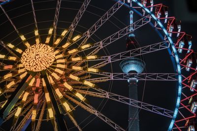 Low angle view of illuminated ferris wheel at night