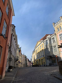 Street amidst buildings in town against sky