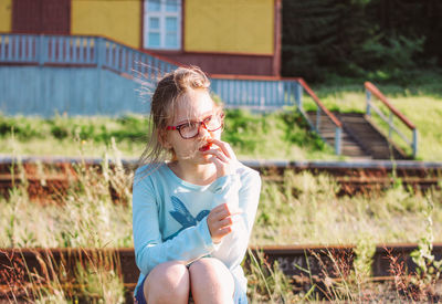 Girl sitting outdoors