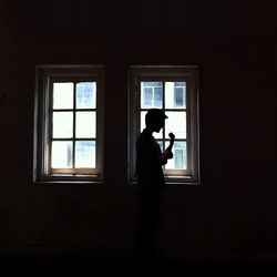 Woman looking through window