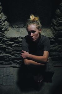 Portrait of a depressed woman in basement