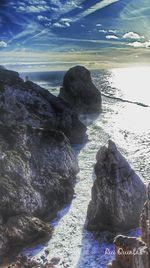 Rocks on beach against sky