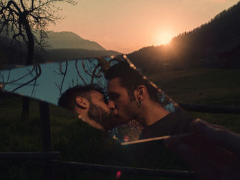 Reflection of romantic gay couple on mirror