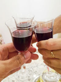 Cropped hand toasting wine