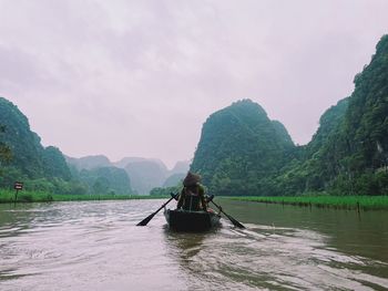 Man rowing boat in lake