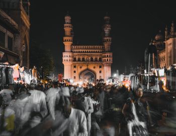 Group of people on city street at night