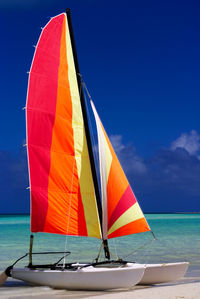 Boat sailing in sea against blue sky