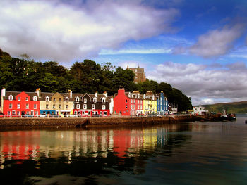 Built structure in water against cloudy sky