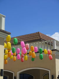 Low angle view of multi colored balloons against building