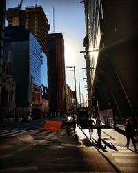 City street and buildings against sky