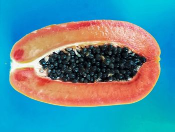 Close-up of lemon slice against blue background