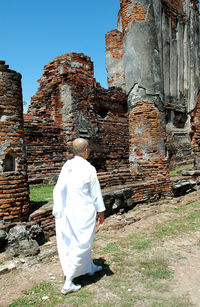 Rear view of a woman at temple against clear sky