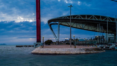 Bridge over sea against sky in city