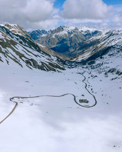 Scenic view of snowcapped mountains against cloudy sky