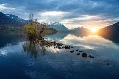 Scenic view of lake against sky during sunset