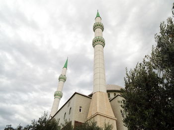 Low angle view of built structure against cloudy sky