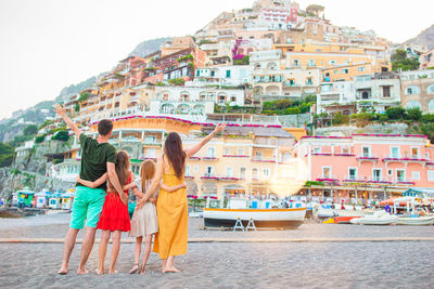 Panoramic view of people on mountain by city against sky