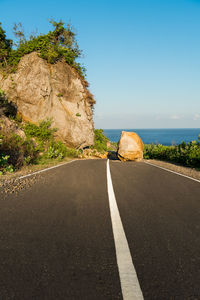 Road amidst rock formation against sky