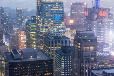 Aerial view of illuminated buildings in city