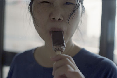 Portrait of woman eating ice cream