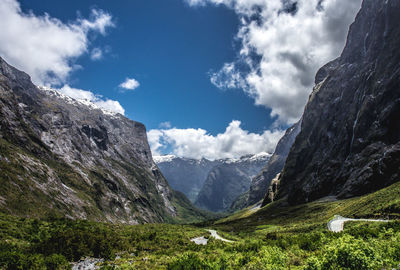 Scenic view of mountains against cloudy sky