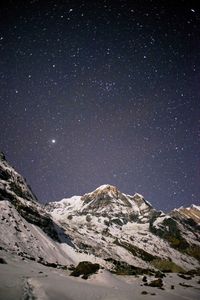 Scenic view of mountains against sky at night