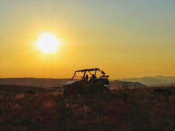 Scenic view of field against sky during sunset