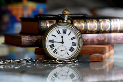 Close-up of pocket watch on table