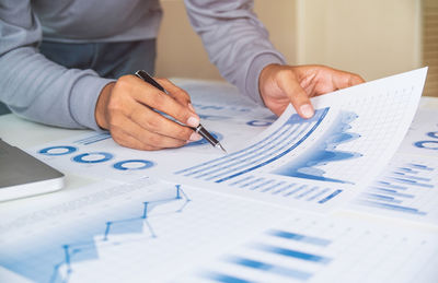 Midsection of man working on paper