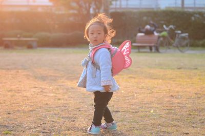 Full length of cute baby girl on field