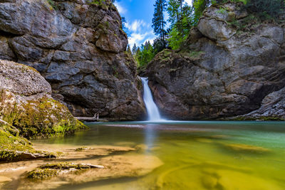 Scenic view of waterfall amidst rocks