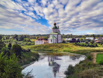 River amidst buildings against sky