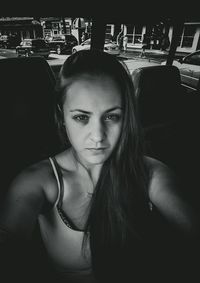 Portrait of beautiful young woman in car