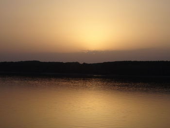 Scenic view of lake against sky during sunset