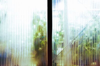 Close-up of sea against sky seen through window