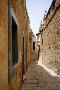 Narrow alley along old buildings