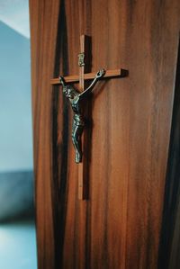 Close-up of cross on metal door