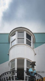 Low angle view of building by sea against sky