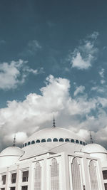 Low angle view of building against cloudy sky