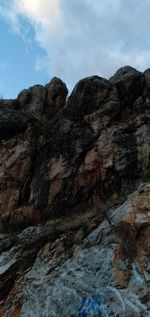 Low angle view of rock formation against sky