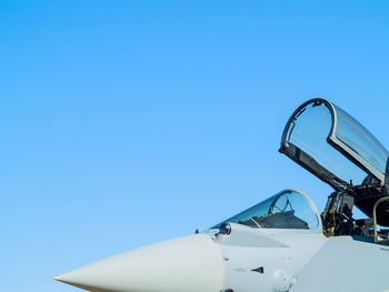 Close-up of helicopter flying against clear blue sky