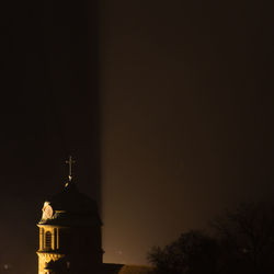 Low angle view of bell tower against sky at night