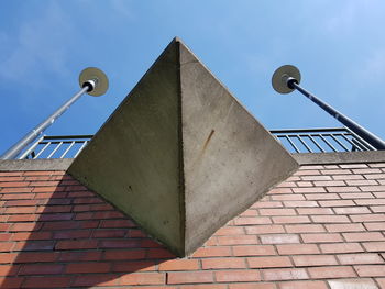 Low angle view of street light against building