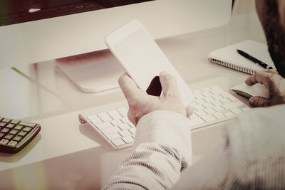 High angle view of man working on paper